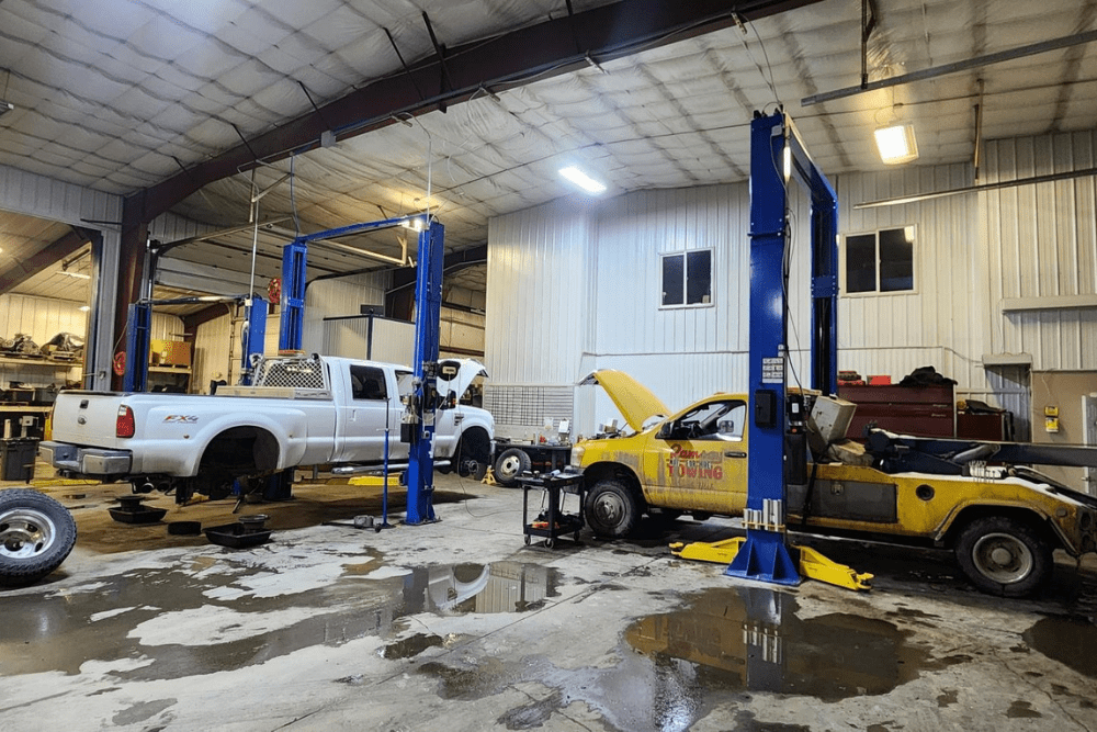 fleet maintenance, diesel repair in Palmer, AK at 1023 Diesel & Fleet. An image of two two trucks in a repair shop ready for maintenance.