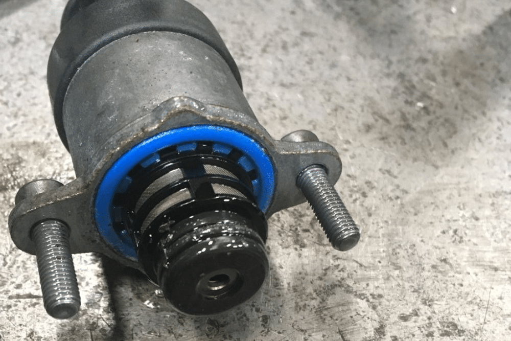 CP4 failure repair in Palmer, AK by 1023 Diesel & Fleet. Image of a Ford 6.7 Powerstroke CP4 fuel pump with visible metal debris and signs of fuel contamination.