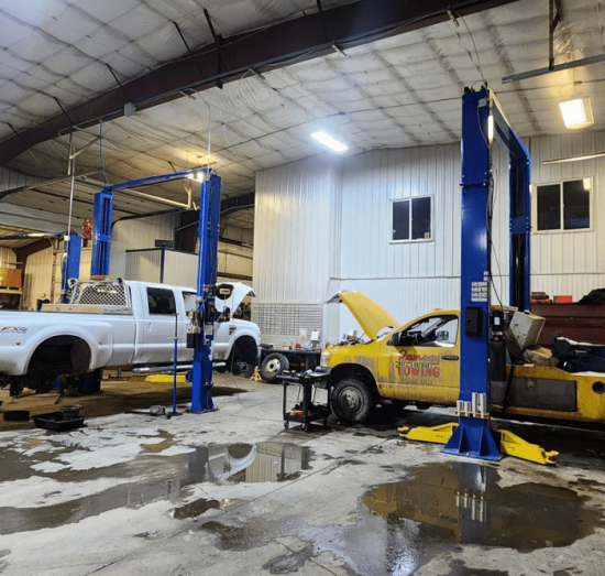 fleet maintenance, diesel repair in Palmer, AK at 1023 Diesel & Fleet. An image of two two trucks in a repair shop ready for maintenance.