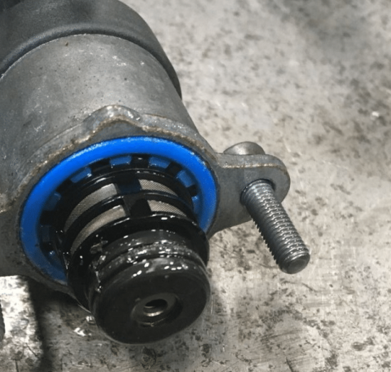 CP4 failure repair in Palmer, AK by 1023 Diesel & Fleet. Image of a Ford 6.7 Powerstroke CP4 fuel pump with visible metal debris and signs of fuel contamination.